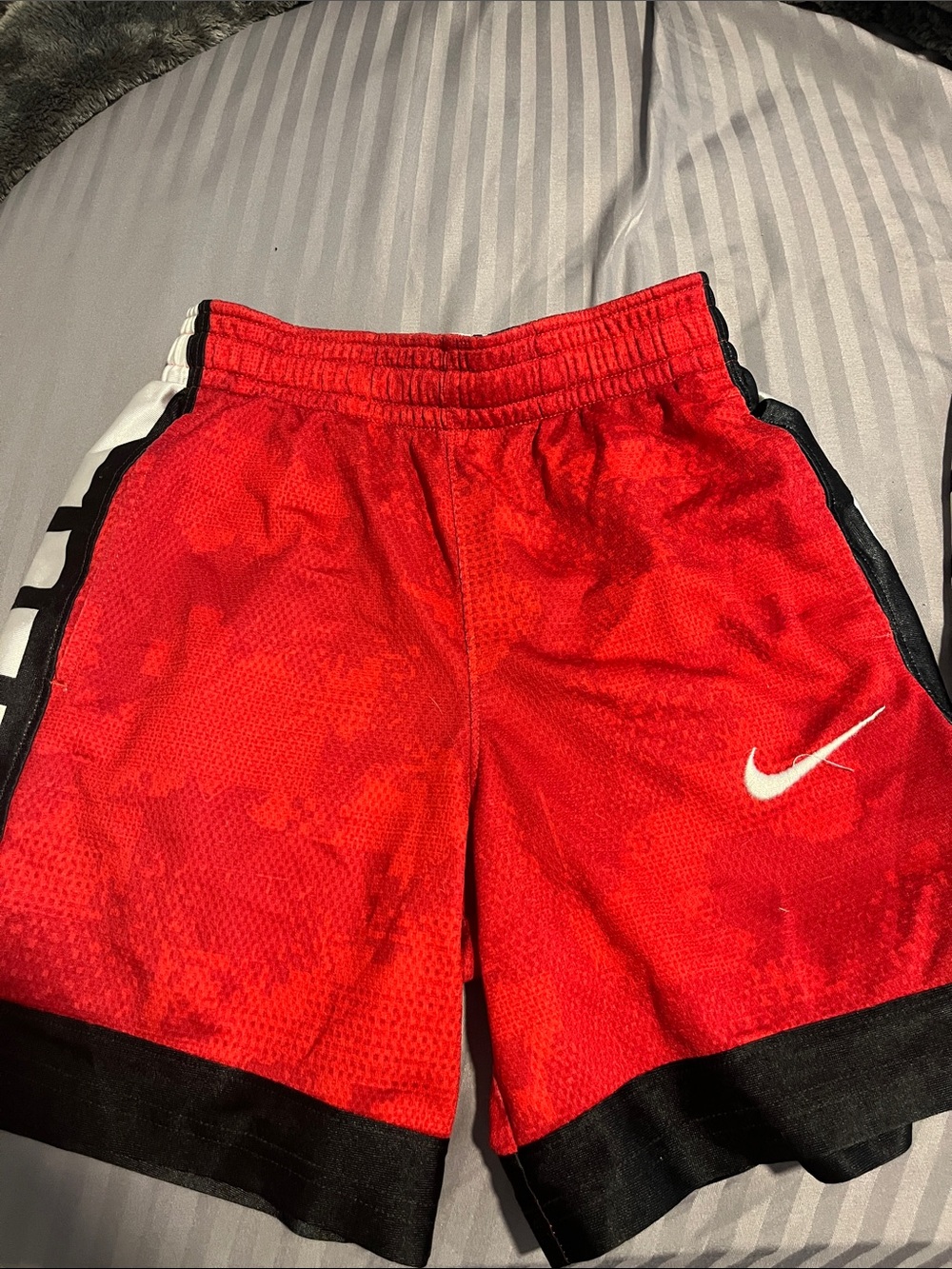 Nike Red Athletic Shorts with Black Trim and White Swoosh